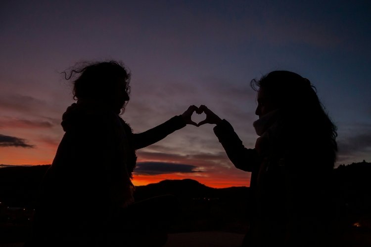 two people joining hands in heart shape creating boundaries